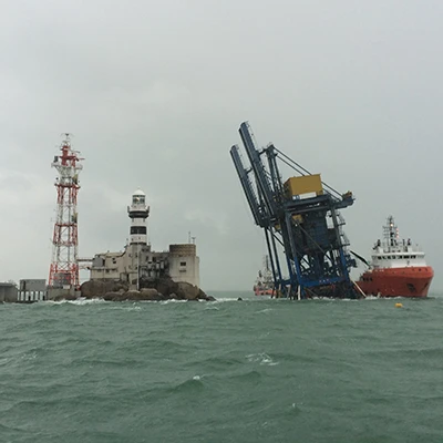 Temporary docks set up between a light house and a large vessel